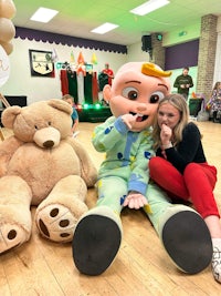 a woman posing with a teddy bear